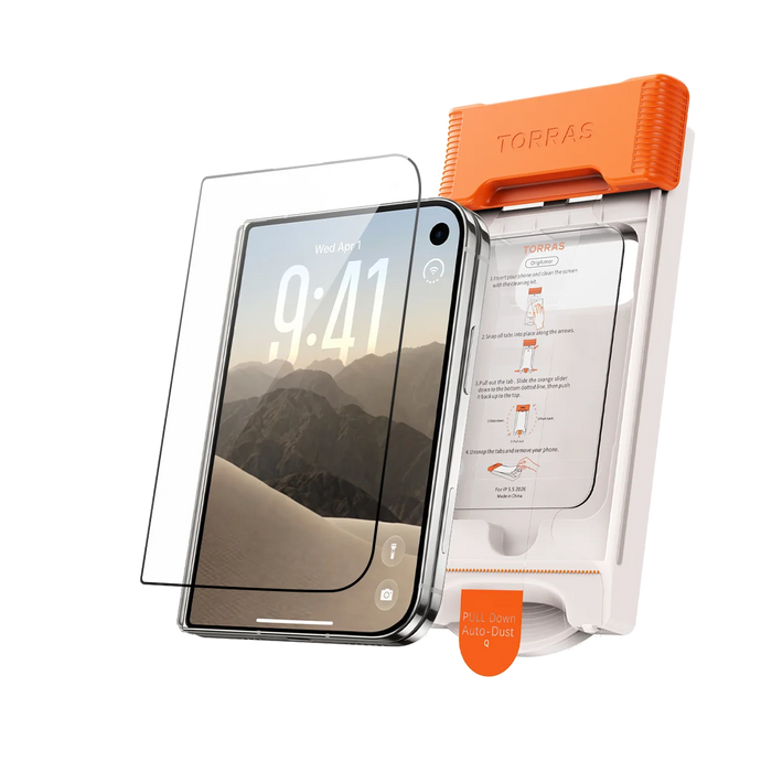 A screen protector and the orange TORRAS auto-dust installation frame standing beside the phone they fit, a desert mountain wallpaper on screen