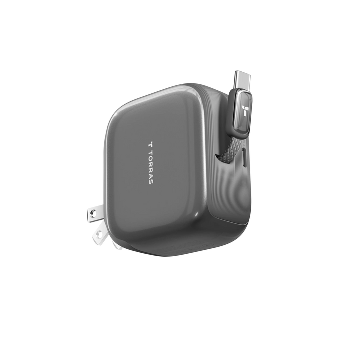 A graphite TORRAS folding wall charger with its retractable USB-C connector pulled out and the prongs folding away