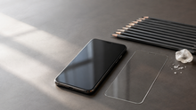 Smartphone, clear screen protector, graphite pencils, and quartz illustrating what 9H hardness means