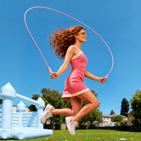 Woman skipping outdoors with a pink TORRAS NeoCable 60W cable, showing its 6.56ft length