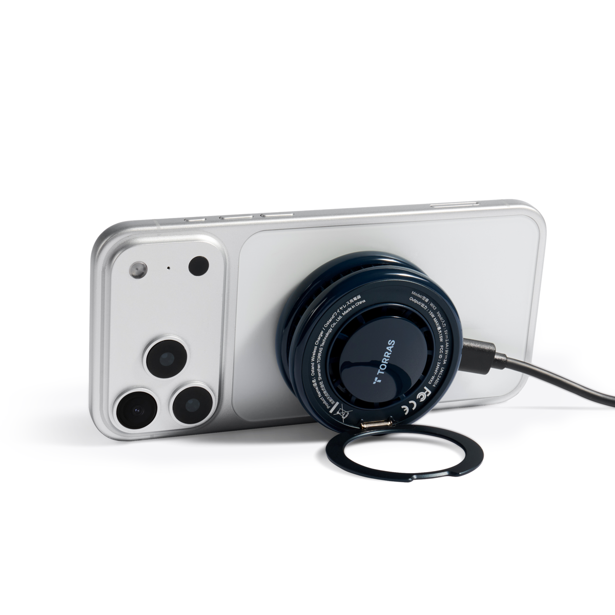 Obsidian Black PolarCircle charger magnetically attached to the back of a phone with its ring stand folded out to prop the phone up