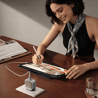 TORRAS IceCore 67W charger powering an iPad while a woman draws at a desk