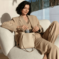 Woman taking the compact TORRAS IceCore 67W charger out of her handbag indoors