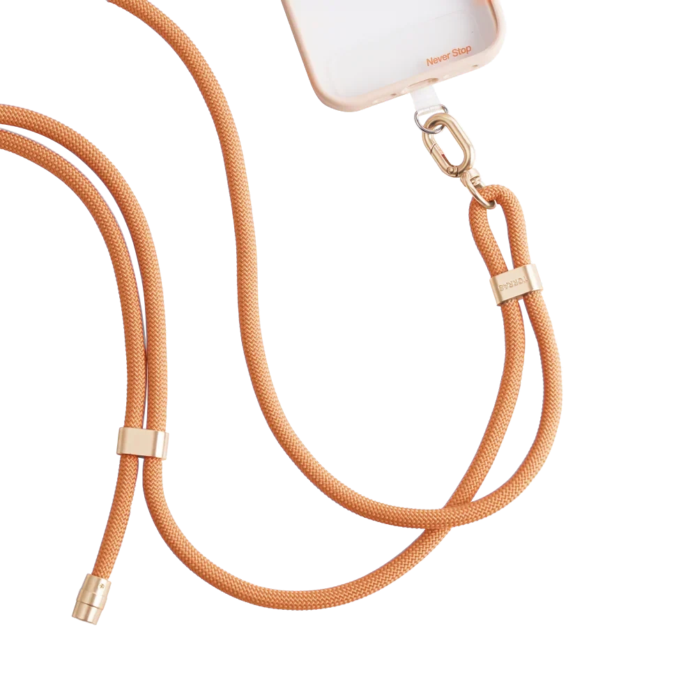 LoopGo Flex crossbody phone lanyard in orange, clipped to a clear phone case
