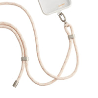 LoopGo Flex crossbody phone lanyard in sand beige, clipped to a clear phone case