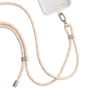 LoopGo Flex crossbody phone lanyard in sand beige, clipped to a clear phone case