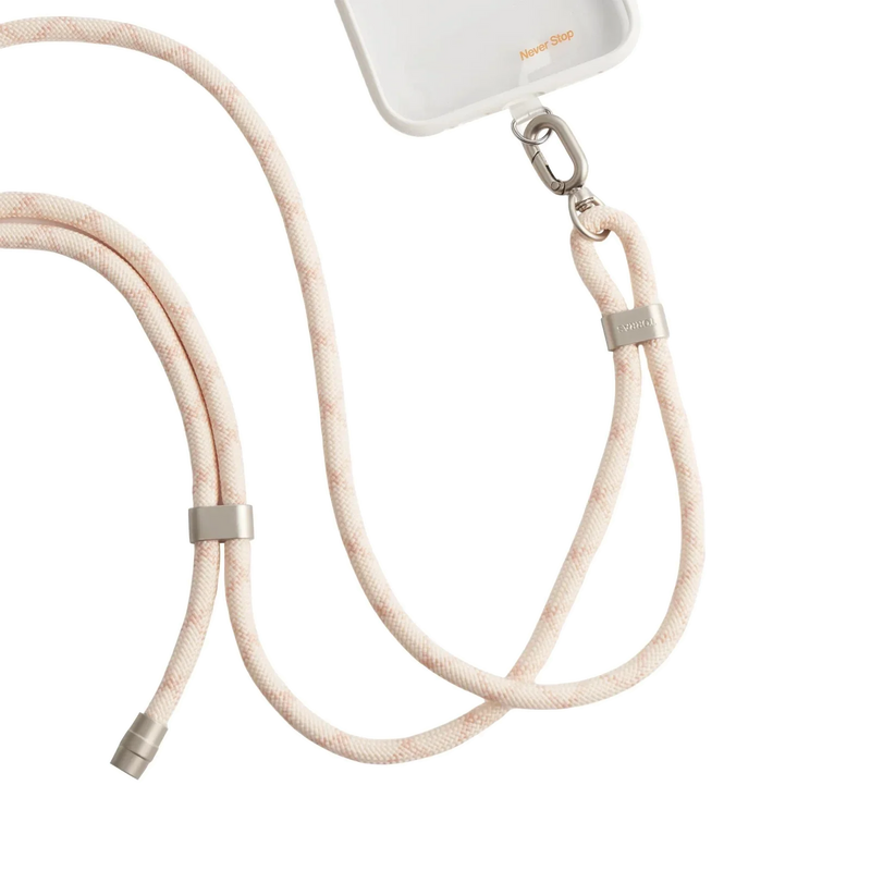 LoopGo Flex crossbody phone lanyard in sand beige, clipped to a clear phone case