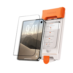 A screen protector and the orange TORRAS auto-dust installation frame standing beside the phone they fit, a desert mountain wallpaper on screen