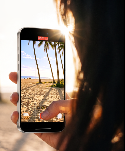 Cyclist's view of a phone on the handlebars showing a clear map while sun glares off the sea