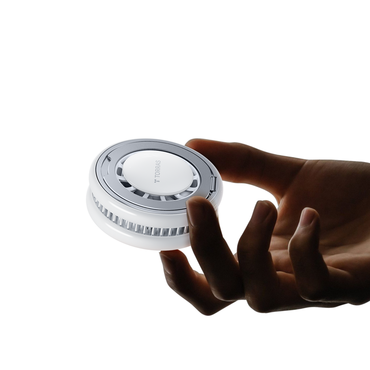Hand holding the compact PolarCircle wireless charger, showing its palm-sized scale and side cooling vents
