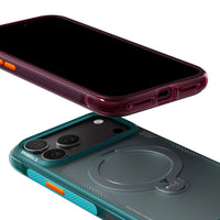 Plum and pine-green Ostand Q3 Air cases stacked at an angle, screens dark, orange side buttons in view