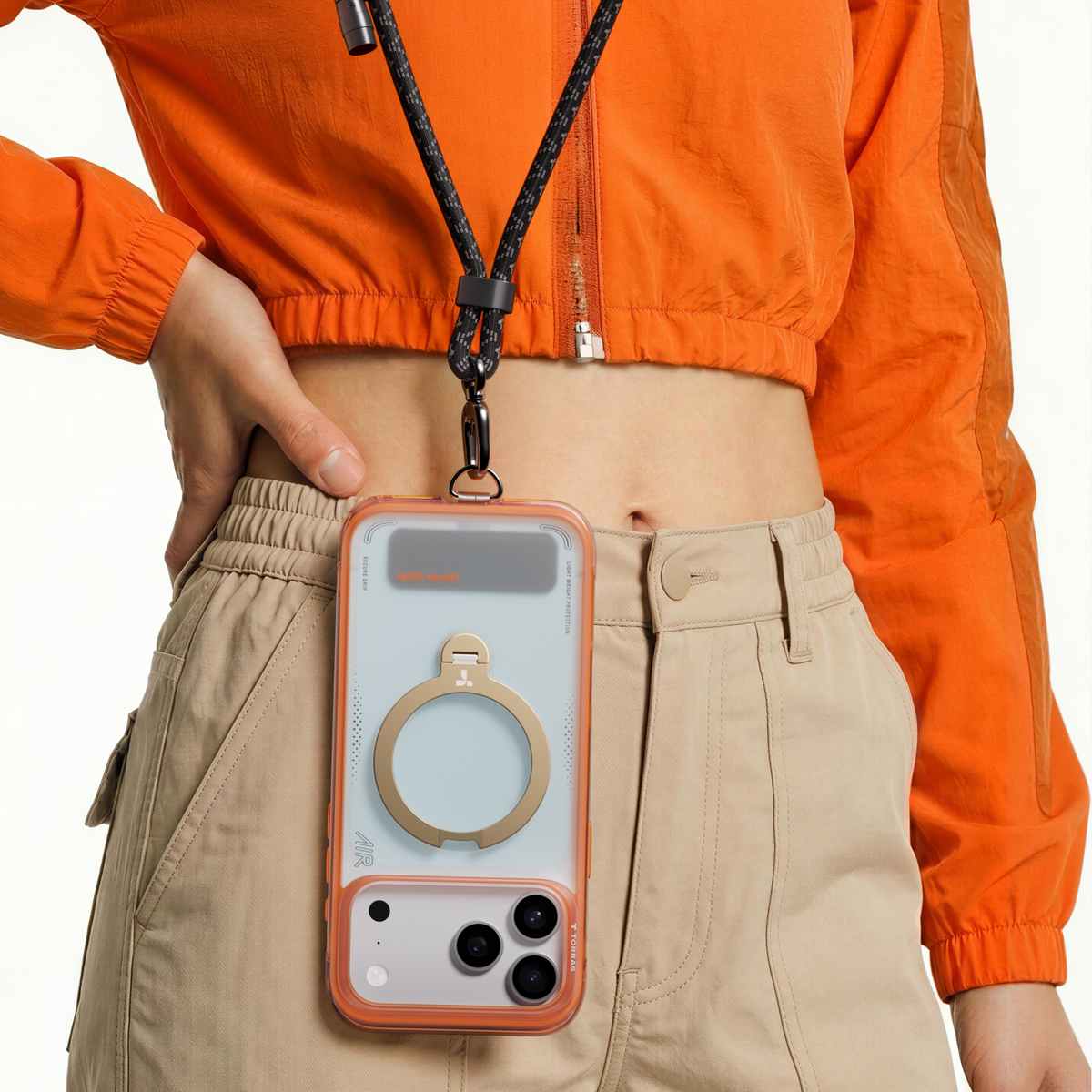 Coral Q3 Air Summer case on a crossbody lanyard at the hip, gold ring stand facing out