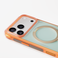 Close-up of the coral Q3 Air Summer case: orange frame, grey grip pad and gold magnetic ring