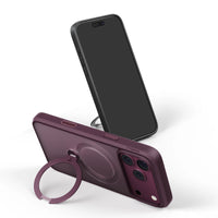 Wine-purple Q3 Spin case resting on its ring kickstand beside an iPhone 18 Pro Max standing screen-out
