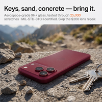 Cherry red iPhone 18 Pro with LensGuard resting on rocky ground beside keys, illustrating the scratch test