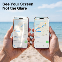 Two hands holding phones at the beach, comparing a glare-free map screen with a reflective one