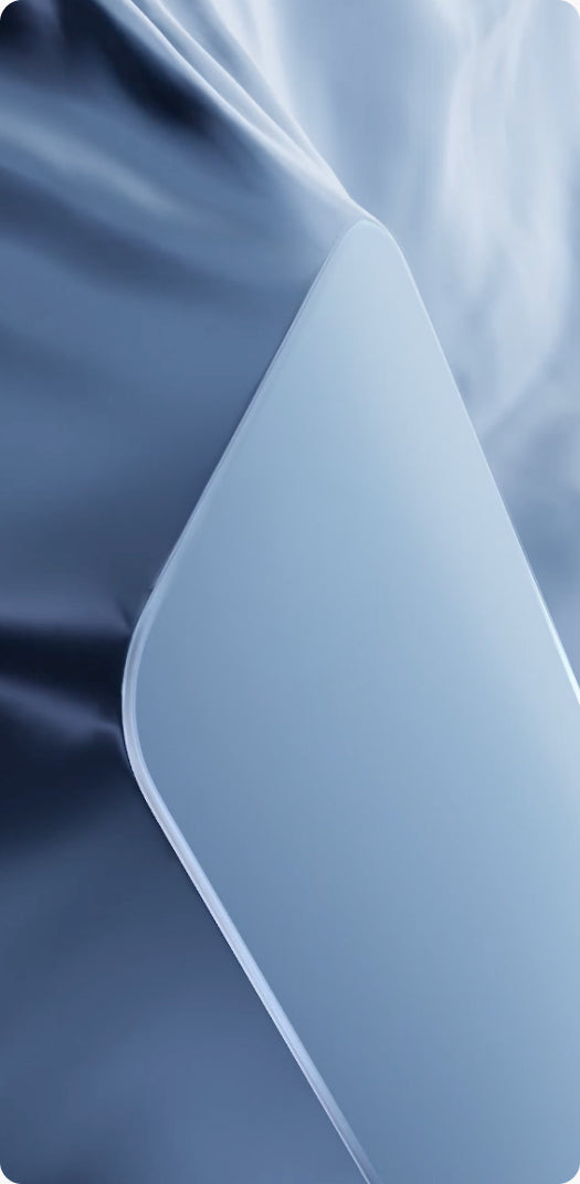 Close-up of a single TORRAS glass protector on blue fabric, edge catching the light