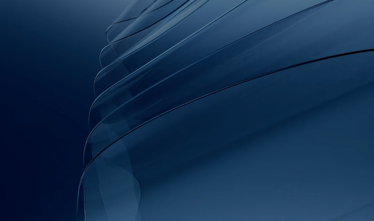 A TORRAS SunView AR sheet lying on deep blue silk, its surface holding almost no reflection