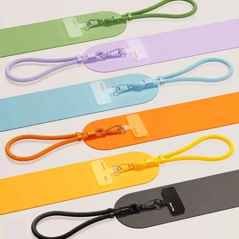 Wrist lanyards in green, lilac, blue, orange, yellow and black with their adapter pads