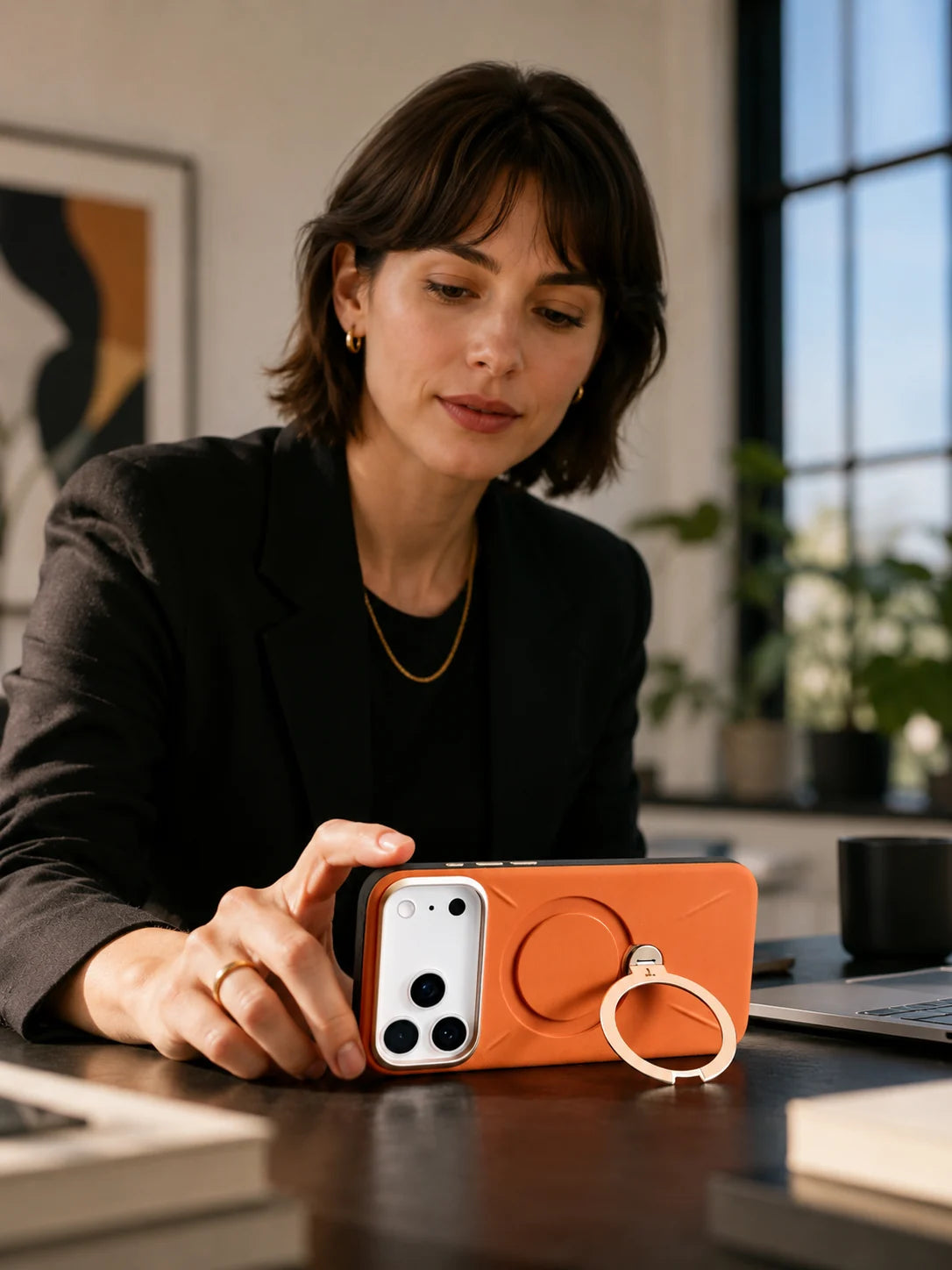 Business traveller holding an iPhone in a MagSafe-ready TORRAS Ostand case.