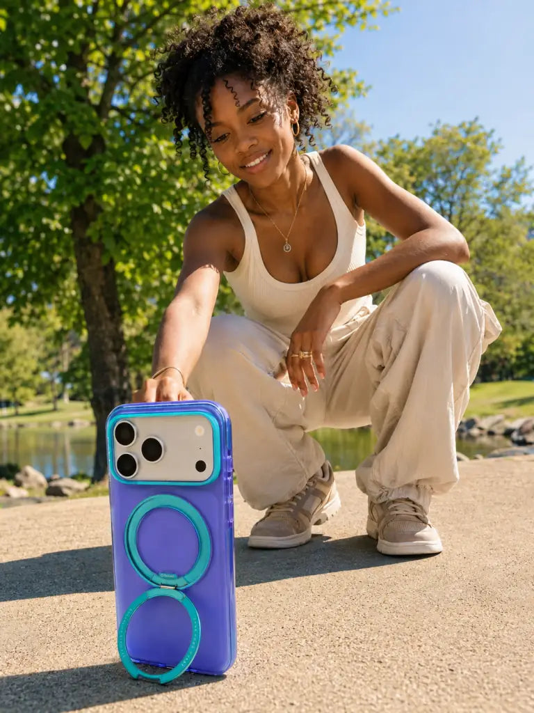Outdoor summer scene with an iPhone in a TORRAS Ostand case propped on its ring stand.